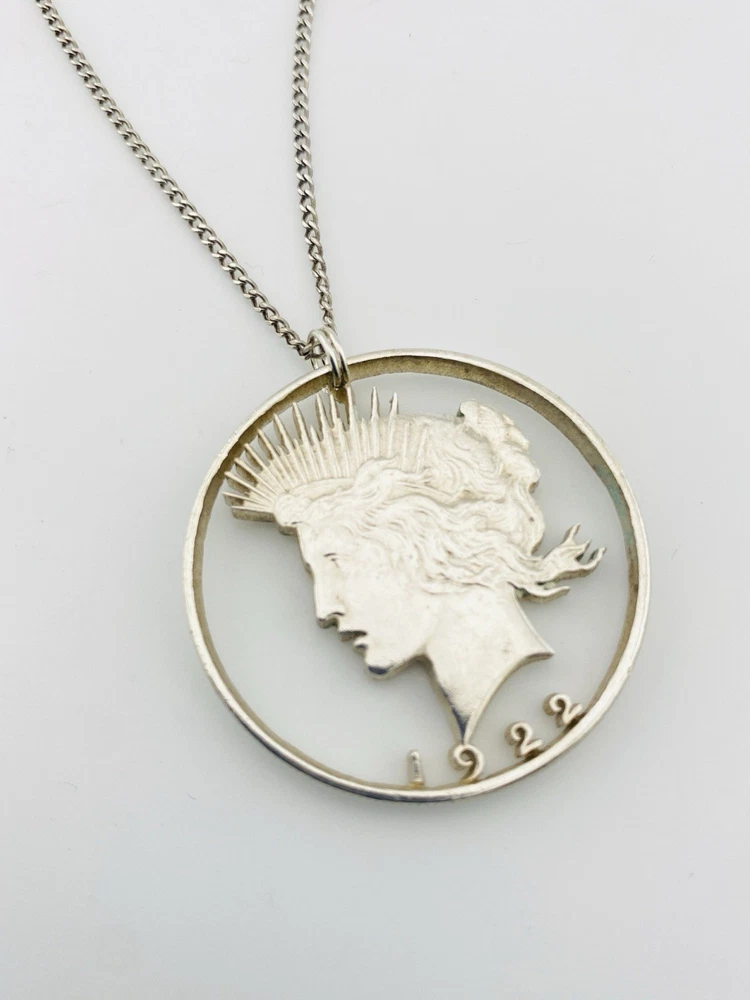 Hand cut Peace Dollar silver coin pendant detail