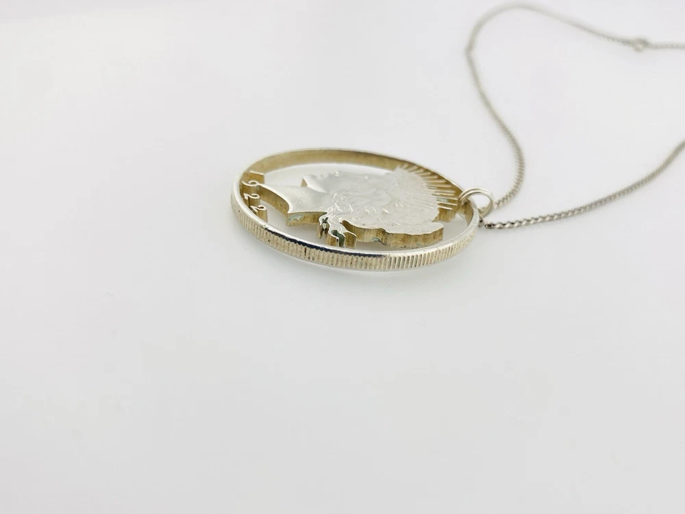 Hand cut Peace Dollar silver coin pendant detail
