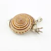 Sterling silver figural snail pendant with natural spiral shell and dimensional artisan design