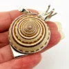 Sterling silver figural snail pendant with natural spiral shell and dimensional artisan design