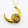 Antique Victorian crescent moon brooch converted into a pendant necklace with a faceted glass stone, enamel accents, and an 18¼-inch gold filled chain.
