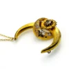 Antique Victorian crescent moon brooch converted into a pendant necklace with a faceted glass stone, enamel accents, and an 18¼-inch gold filled chain.