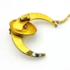 Antique Victorian crescent moon brooch converted into a pendant necklace with a faceted glass stone, enamel accents, and an 18¼-inch gold filled chain.