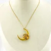 Antique Victorian crescent moon brooch converted into a pendant necklace with a faceted glass stone, enamel accents, and an 18¼-inch gold filled chain.