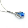 Art Deco shield-form lavalier necklace with cornflower-blue glass and clear paste stones
