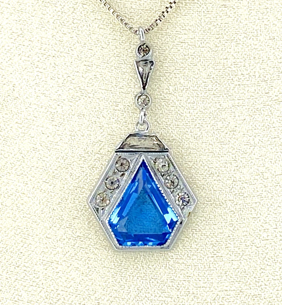 Art Deco shield-form lavalier necklace with cornflower-blue glass and clear paste stones