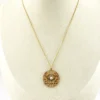 Antique Edwardian round openwork pendant necklace in warm rose gold filled with a likely natural pearl center on a 16-inch chain.
