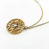 Antique Edwardian round openwork pendant necklace in warm rose gold filled with a likely natural pearl center on a 16-inch chain.