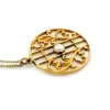 Antique Edwardian round openwork pendant necklace in warm rose gold filled with a likely natural pearl center on a 16-inch chain.