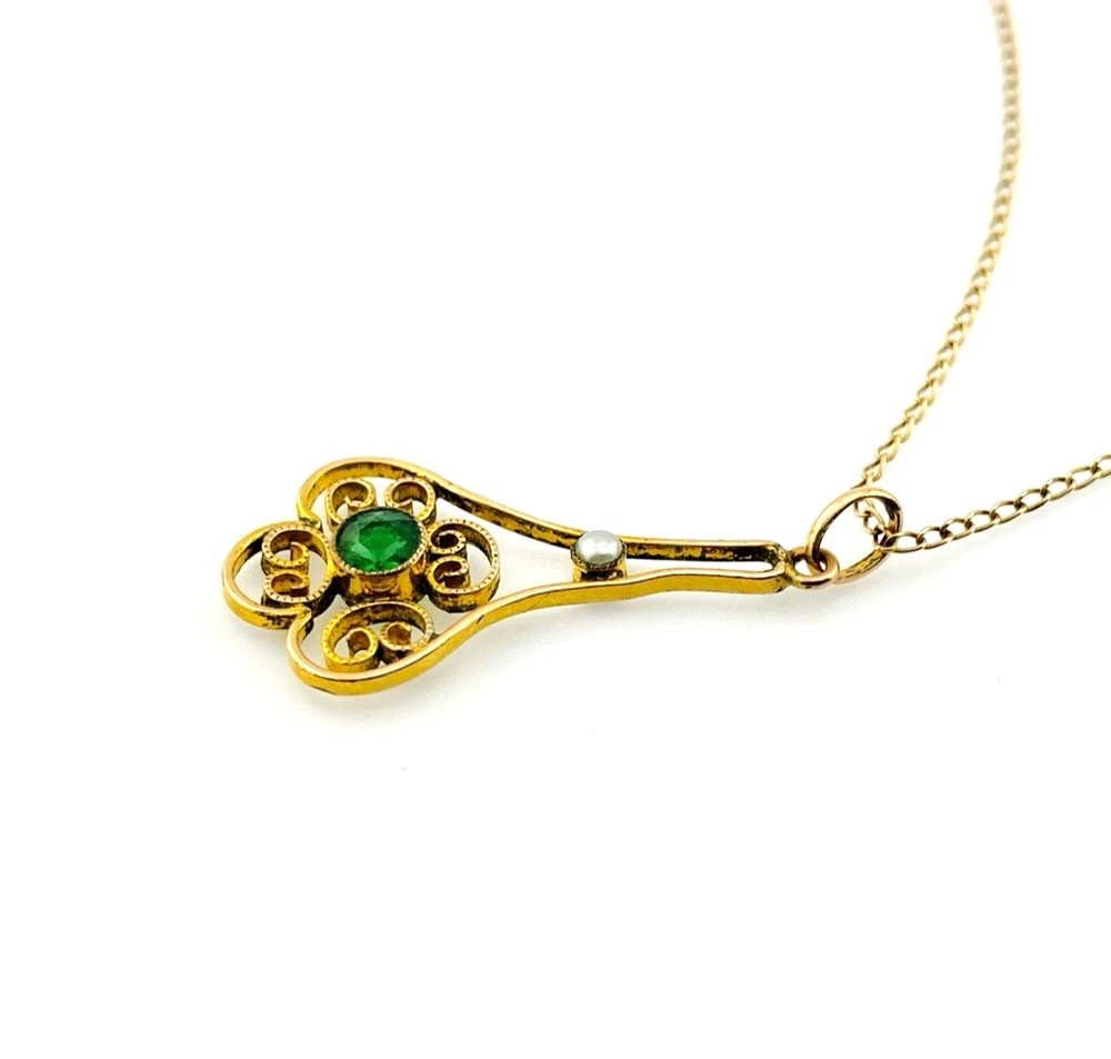 Vintage lavaliere pendant necklace with a faceted green glass stone, genuine pearl accent, and 12K gold filled chain.