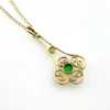 Vintage lavaliere pendant necklace with a faceted green glass stone, genuine pearl accent, and 12K gold filled chain.