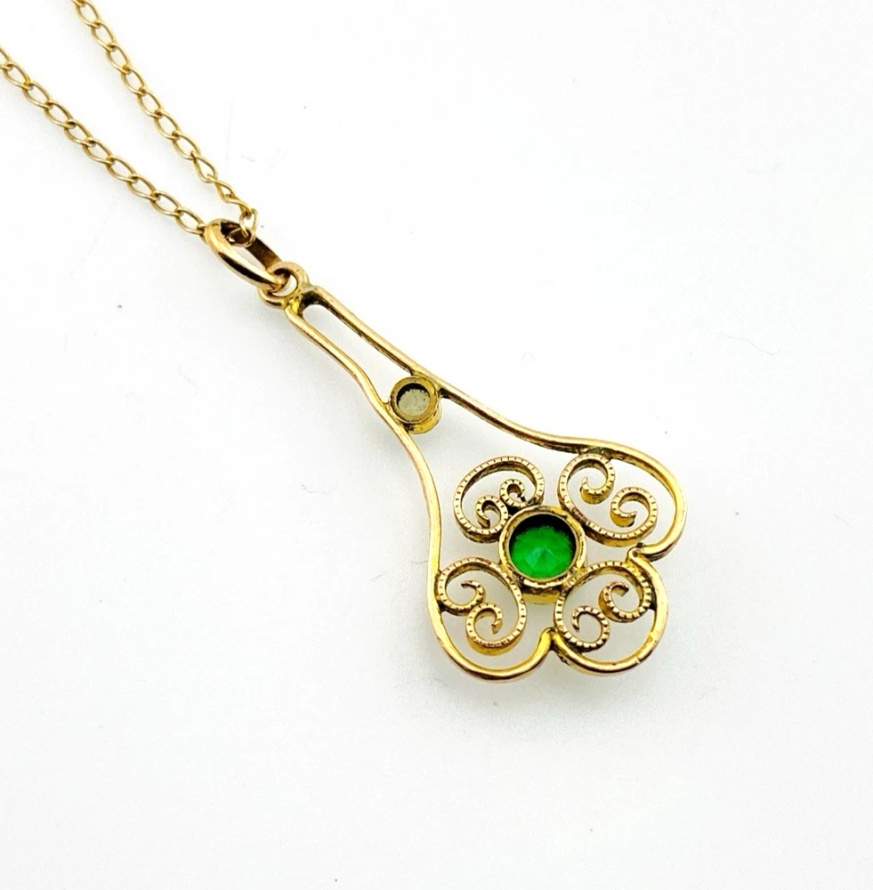 Vintage lavaliere pendant necklace with a faceted green glass stone, genuine pearl accent, and 12K gold filled chain.
