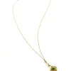 Vintage lavaliere pendant necklace with a faceted green glass stone, genuine pearl accent, and 12K gold filled chain.