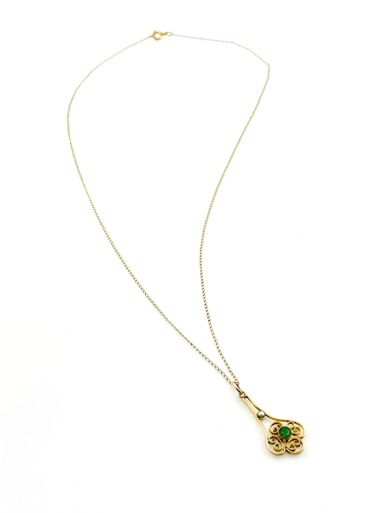 Vintage lavaliere pendant necklace with a faceted green glass stone, genuine pearl accent, and 12K gold filled chain.