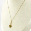 Vintage lavaliere pendant necklace with a faceted green glass stone, genuine pearl accent, and 12K gold filled chain.