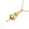 Antique Edwardian solid 9K gold lavaliere pendant with a diamond simulant center, natural baroque pearl drop, and later 12K gold filled chain.