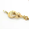 Antique Edwardian solid 9K gold lavaliere pendant with a diamond simulant center, natural baroque pearl drop, and later 12K gold filled chain.