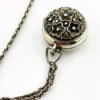 WWII-era sterling silver forget-me-not locket opened to reveal four original family photographs