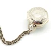 WWII-era sterling silver forget-me-not locket opened to reveal four original family photographs
