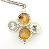 WWII-era sterling silver forget-me-not locket opened to reveal four original family photographs