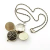 WWII-era sterling silver forget-me-not locket opened to reveal four original family photographs
