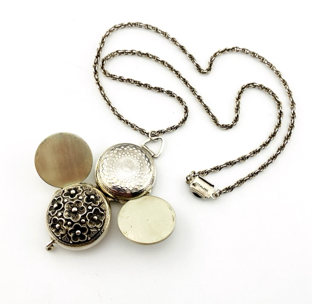 WWII-era sterling silver forget-me-not locket opened to reveal four original family photographs