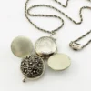 WWII-era sterling silver forget-me-not locket opened to reveal four original family photographs