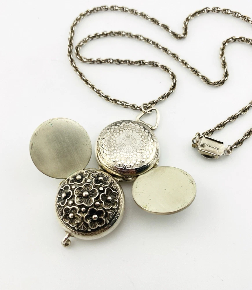 WWII-era sterling silver forget-me-not locket opened to reveal four original family photographs