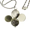 WWII-era sterling silver forget-me-not locket opened to reveal four original family photographs