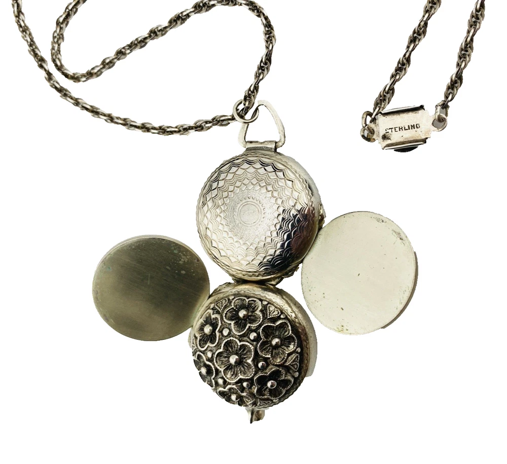 WWII-era sterling silver forget-me-not locket opened to reveal four original family photographs