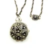WWII-era sterling silver forget-me-not locket opened to reveal four original family photographs