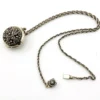 WWII-era sterling silver forget-me-not locket opened to reveal four original family photographs