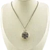 WWII-era sterling silver forget-me-not locket opened to reveal four original family photographs