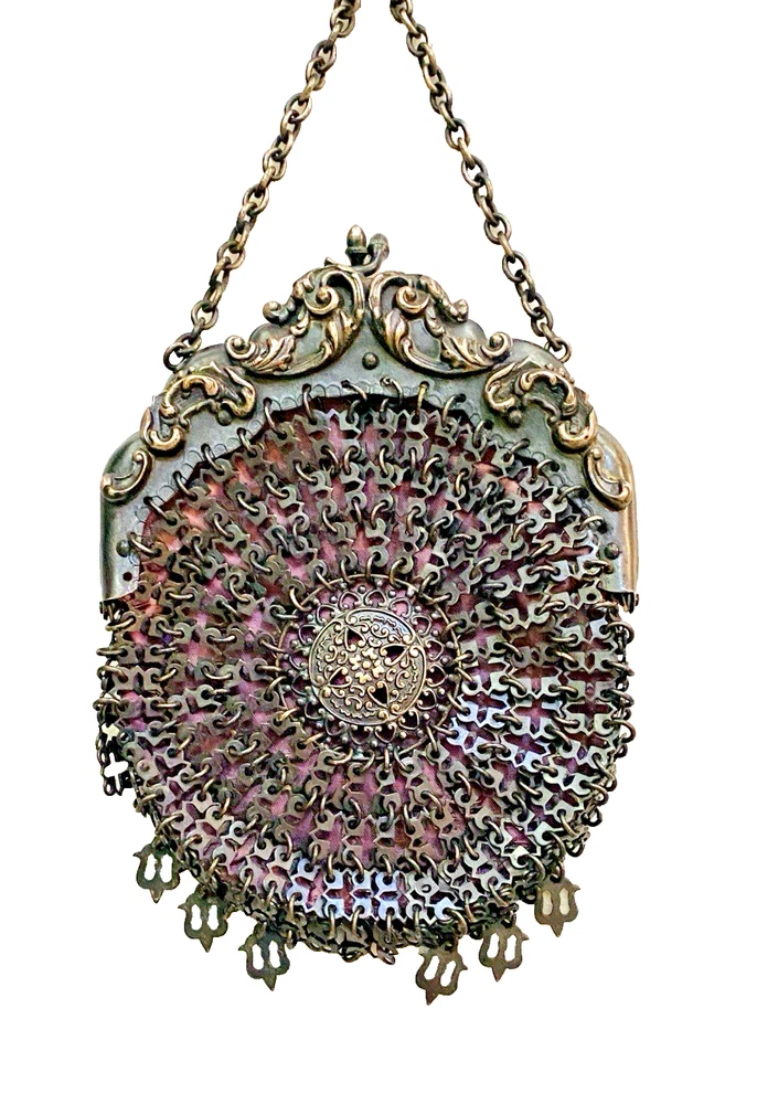 Antique silver-colored chatelaine purse with openwork metal, purple silk lining, fringe, and fleur-de-lis belt clip