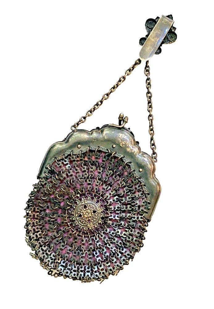 Antique silver-colored chatelaine purse with openwork metal, purple silk lining, fringe, and fleur-de-lis belt clip