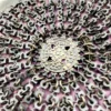 Antique silver-colored chatelaine purse with openwork metal, purple silk lining, fringe, and fleur-de-lis belt clip
