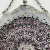Antique silver-colored chatelaine purse with openwork metal, purple silk lining, fringe, and fleur-de-lis belt clip
