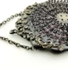 Antique silver-colored chatelaine purse with openwork metal, purple silk lining, fringe, and fleur-de-lis belt clip