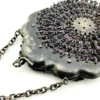 Antique silver-colored chatelaine purse with openwork metal, purple silk lining, fringe, and fleur-de-lis belt clip