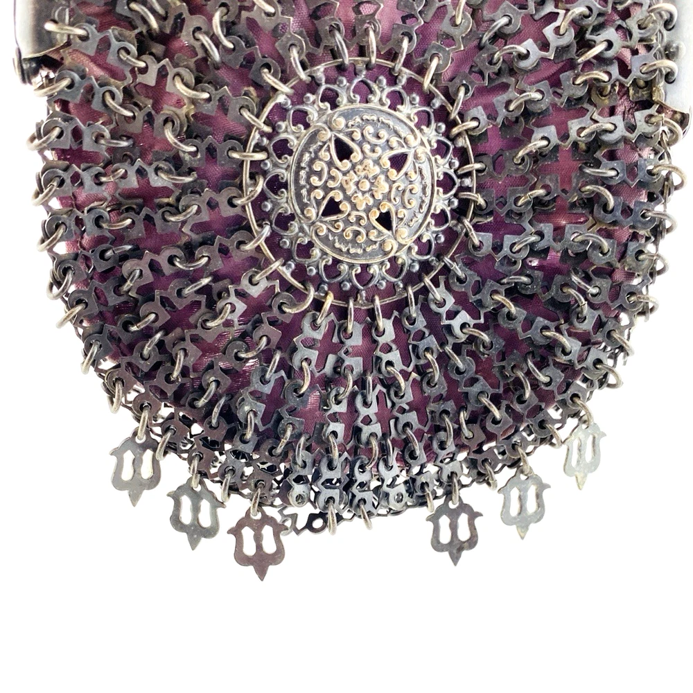 Antique silver-colored chatelaine purse with openwork metal, purple silk lining, fringe, and fleur-de-lis belt clip