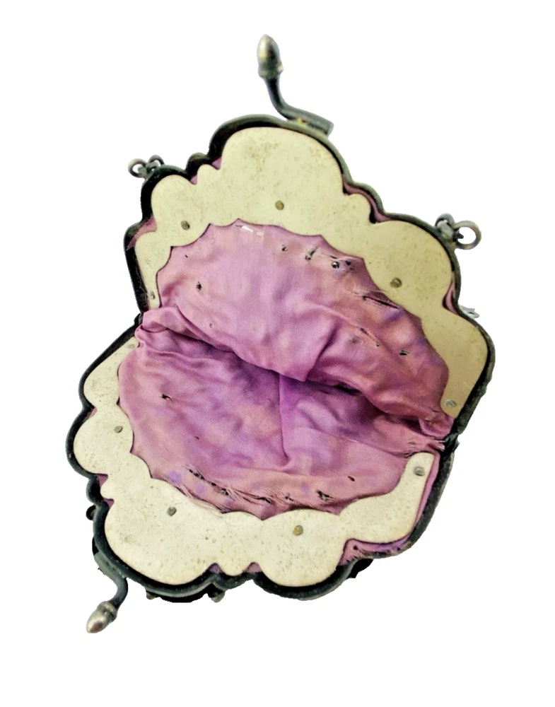 Antique silver-colored chatelaine purse with openwork metal, purple silk lining, fringe, and fleur-de-lis belt clip