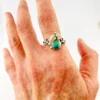 Vintage size 9.75 Southwestern sterling silver ring with teardrop turquoise, engraved leaf, scrolls, and sunburst-stamped silver drop