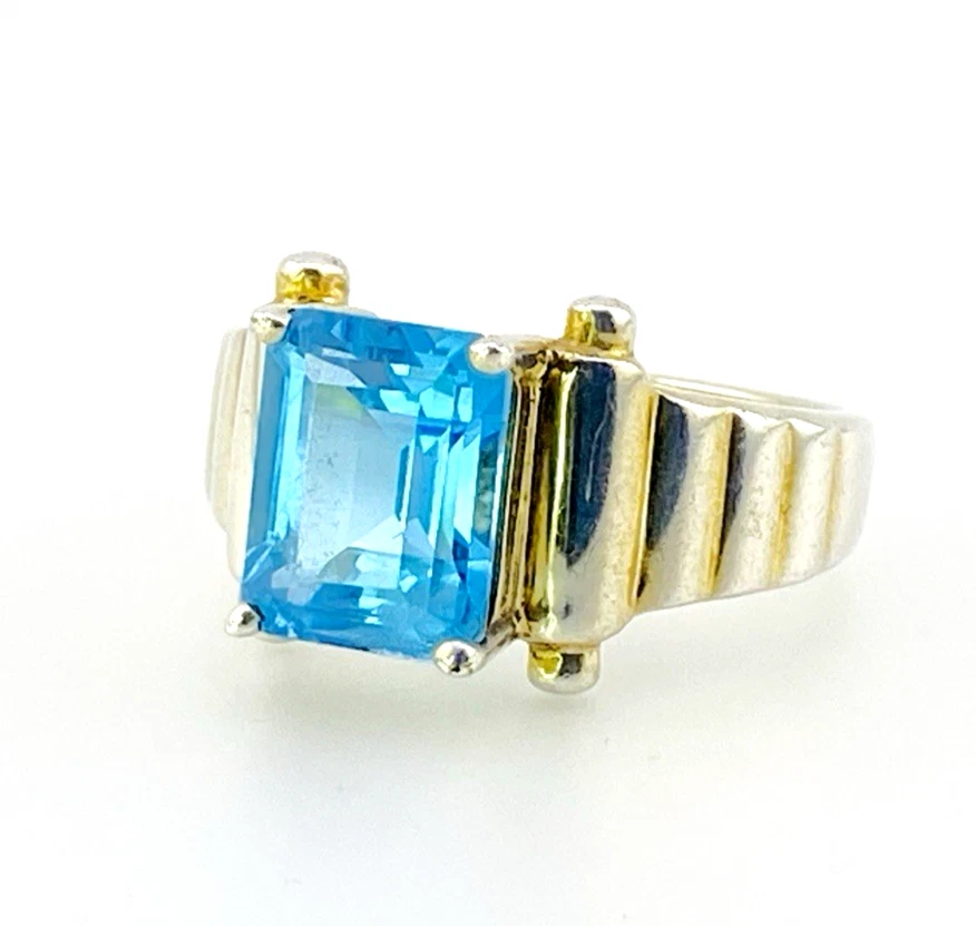 Emerald-cut blue topaz sterling silver ring with fluted architectural shoulders, signed LP, size 7.75