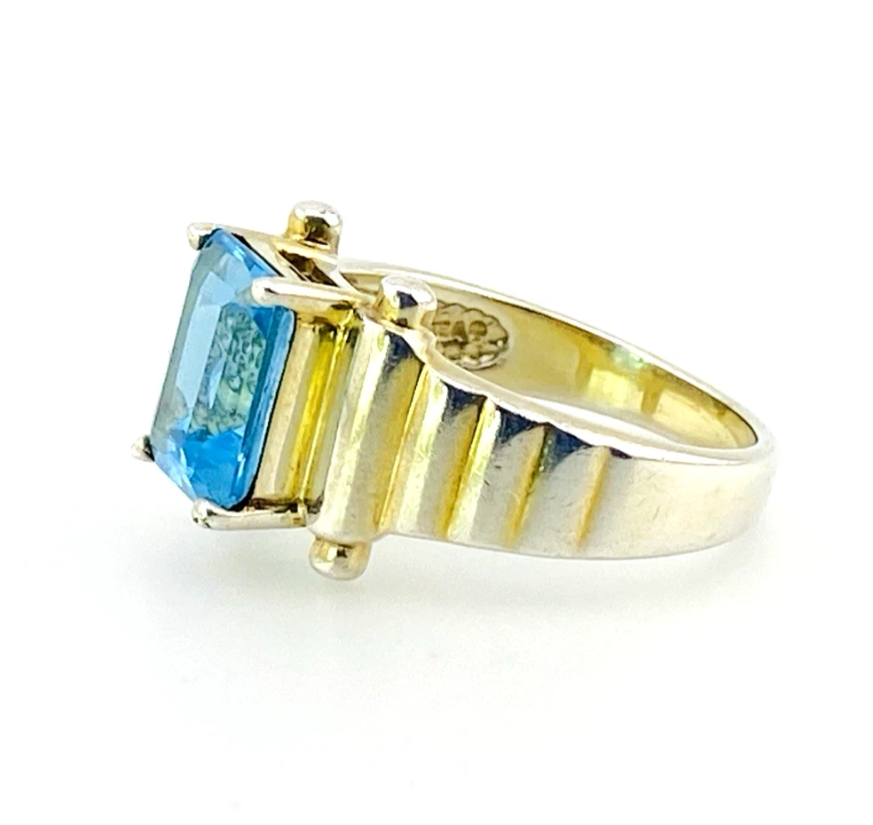 Emerald-cut blue topaz sterling silver ring with fluted architectural shoulders, signed LP, size 7.75