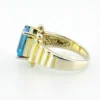 Emerald-cut blue topaz sterling silver ring with fluted architectural shoulders, signed LP, size 7.75