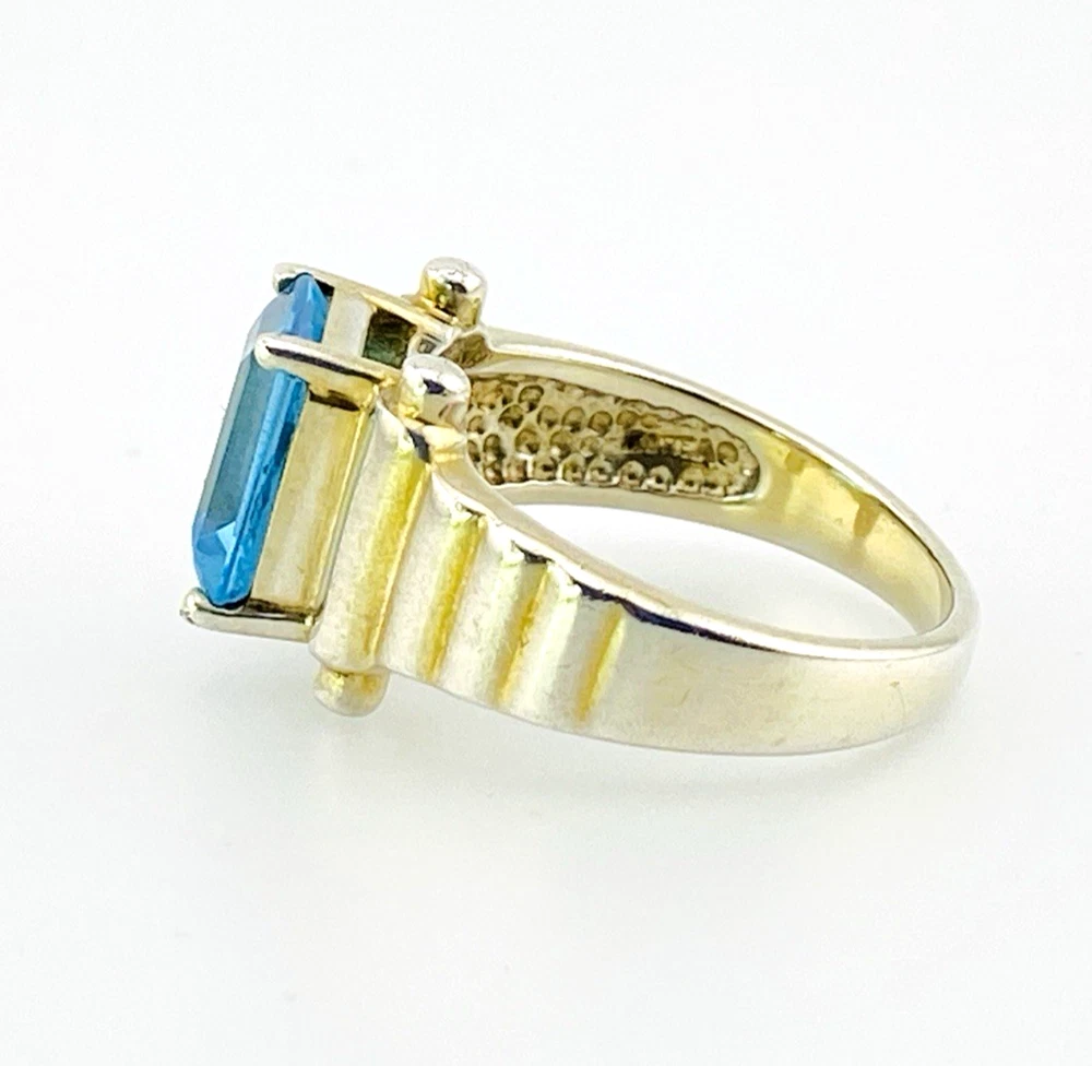 Emerald-cut blue topaz sterling silver ring with fluted architectural shoulders, signed LP, size 7.75
