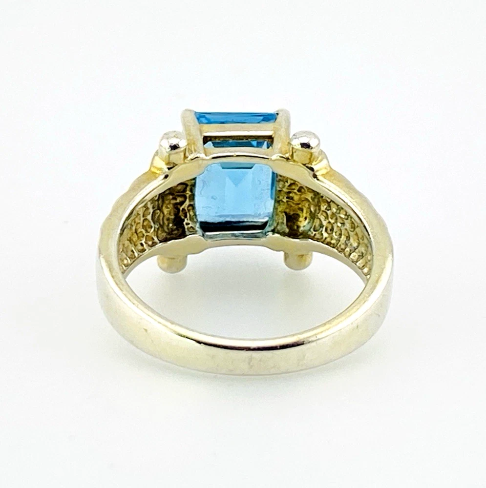 Emerald-cut blue topaz sterling silver ring with fluted architectural shoulders, signed LP, size 7.75