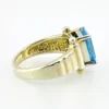 Emerald-cut blue topaz sterling silver ring with fluted architectural shoulders, signed LP, size 7.75