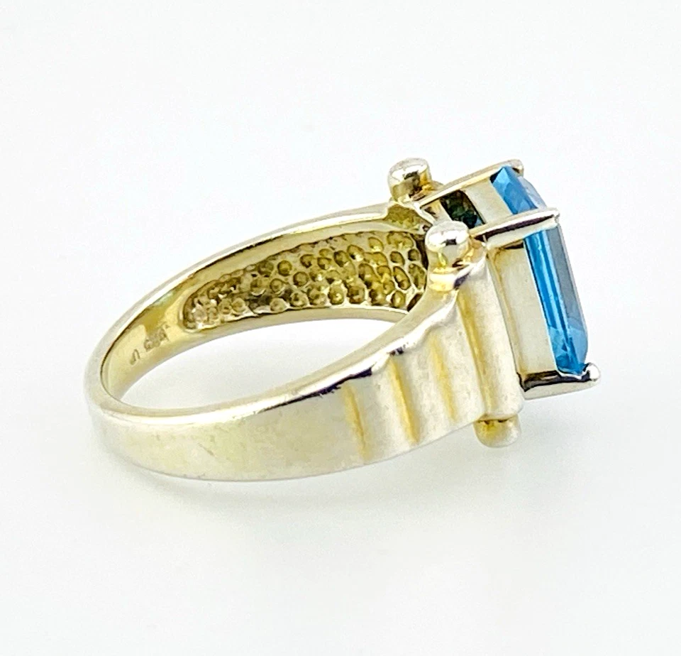 Emerald-cut blue topaz sterling silver ring with fluted architectural shoulders, signed LP, size 7.75