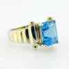 Emerald-cut blue topaz sterling silver ring with fluted architectural shoulders, signed LP, size 7.75